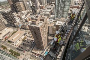 construction workers on swing stage above denver colorado
