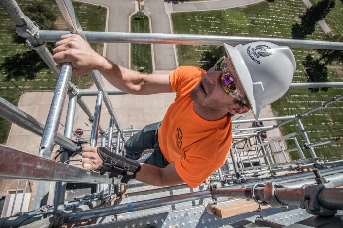 man climbs scaffolding ladder