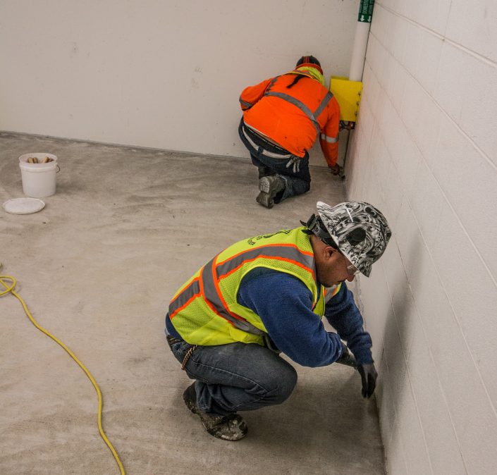 workers apply polyurethane joint sealants