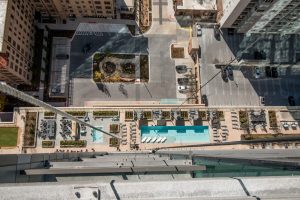 a swing stage hangs off of country club towers in denver colorado