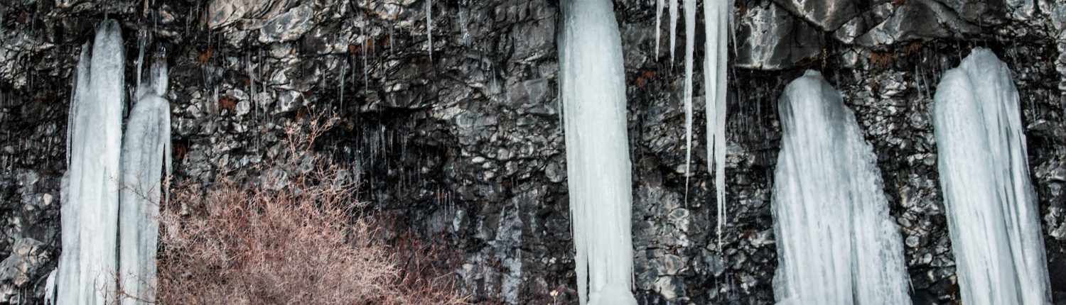 ice seeps from a wall of rock