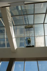 Worker seals atrium windows