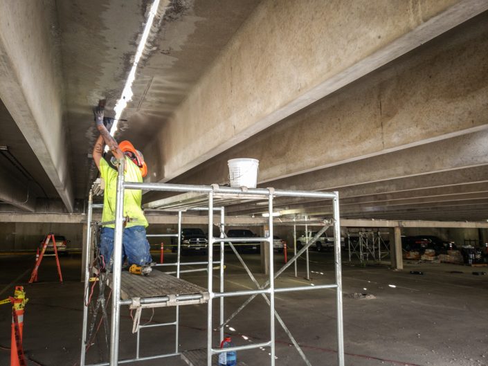 Concrete repairs being made to parking garage ceiling