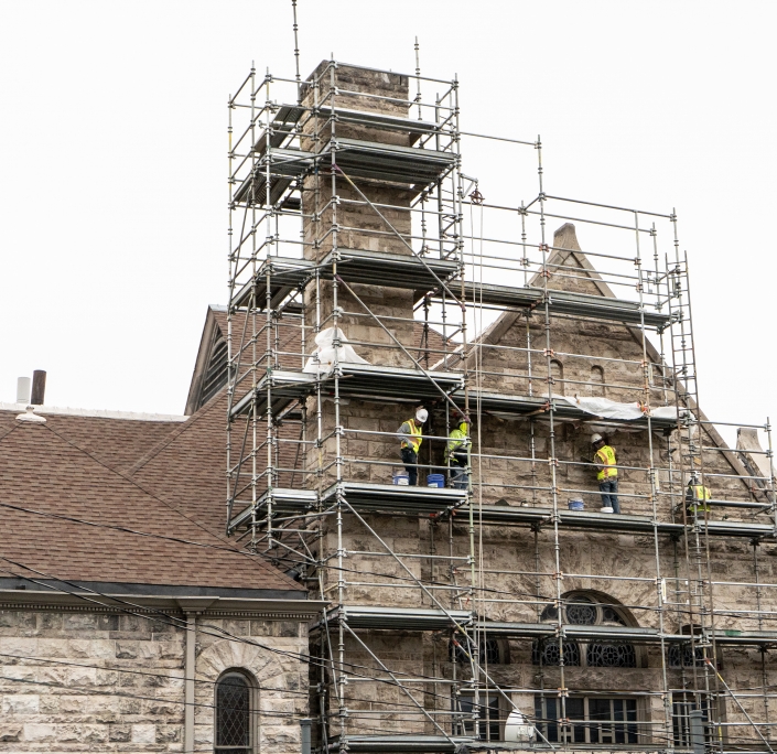 Scaffolding on the side of a stone church