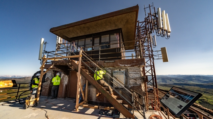 Workers repairing the mt washburn lookout tower in yellowstone